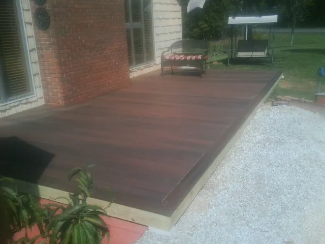 Freshly stained wood deck built against a brick home in Dushore