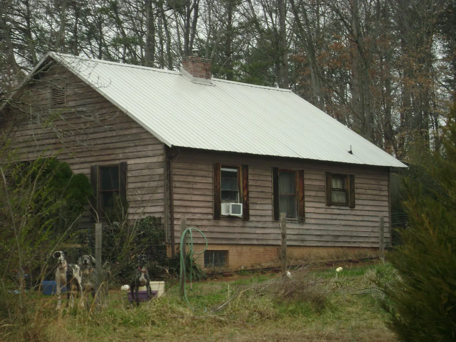 White metal roof on an old wood sided farmhouse, from a Metal Roof Installation job in Dushore